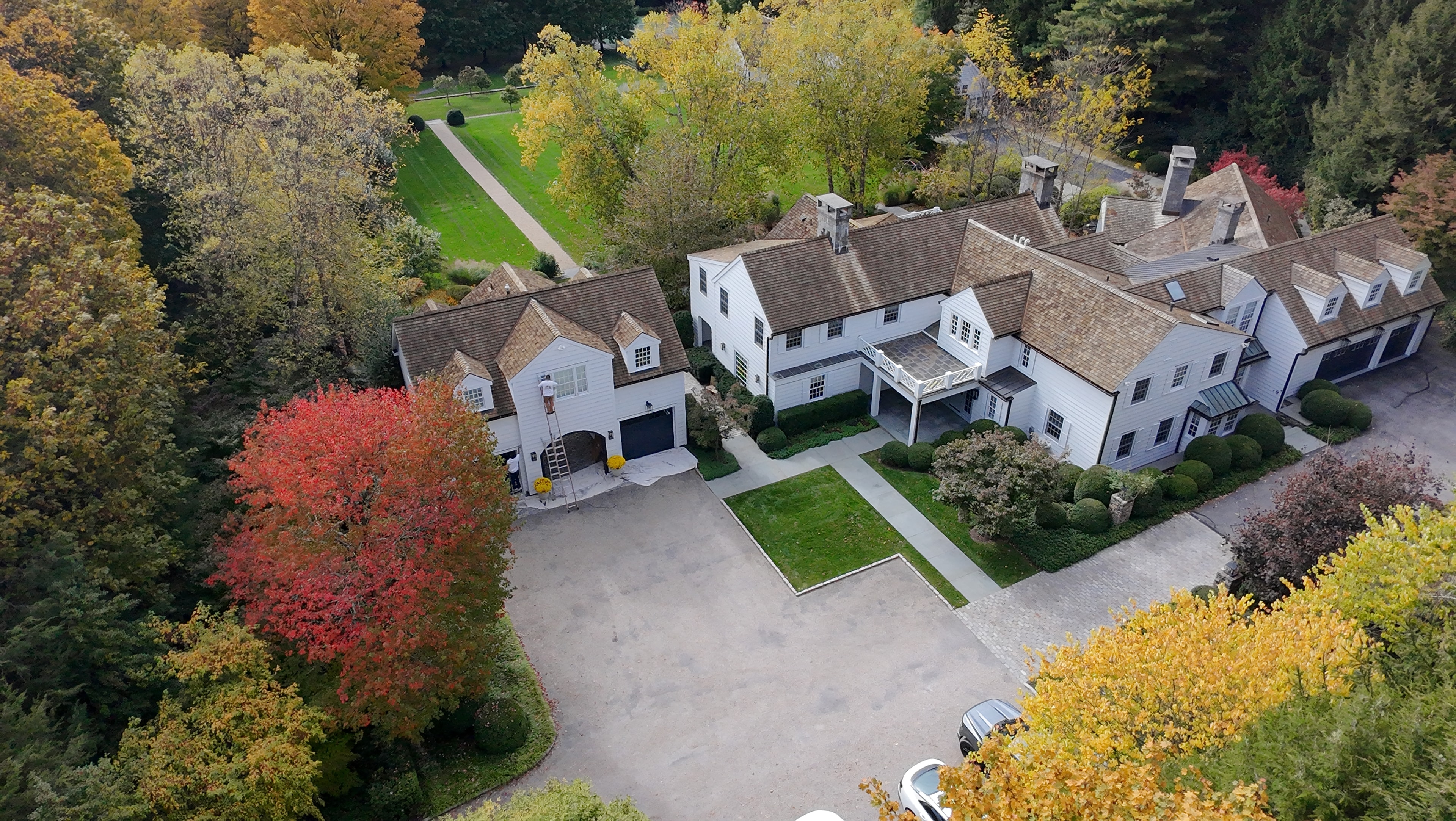 Aerial view of white colonial estate with autumn foliage, Fairfield County CT