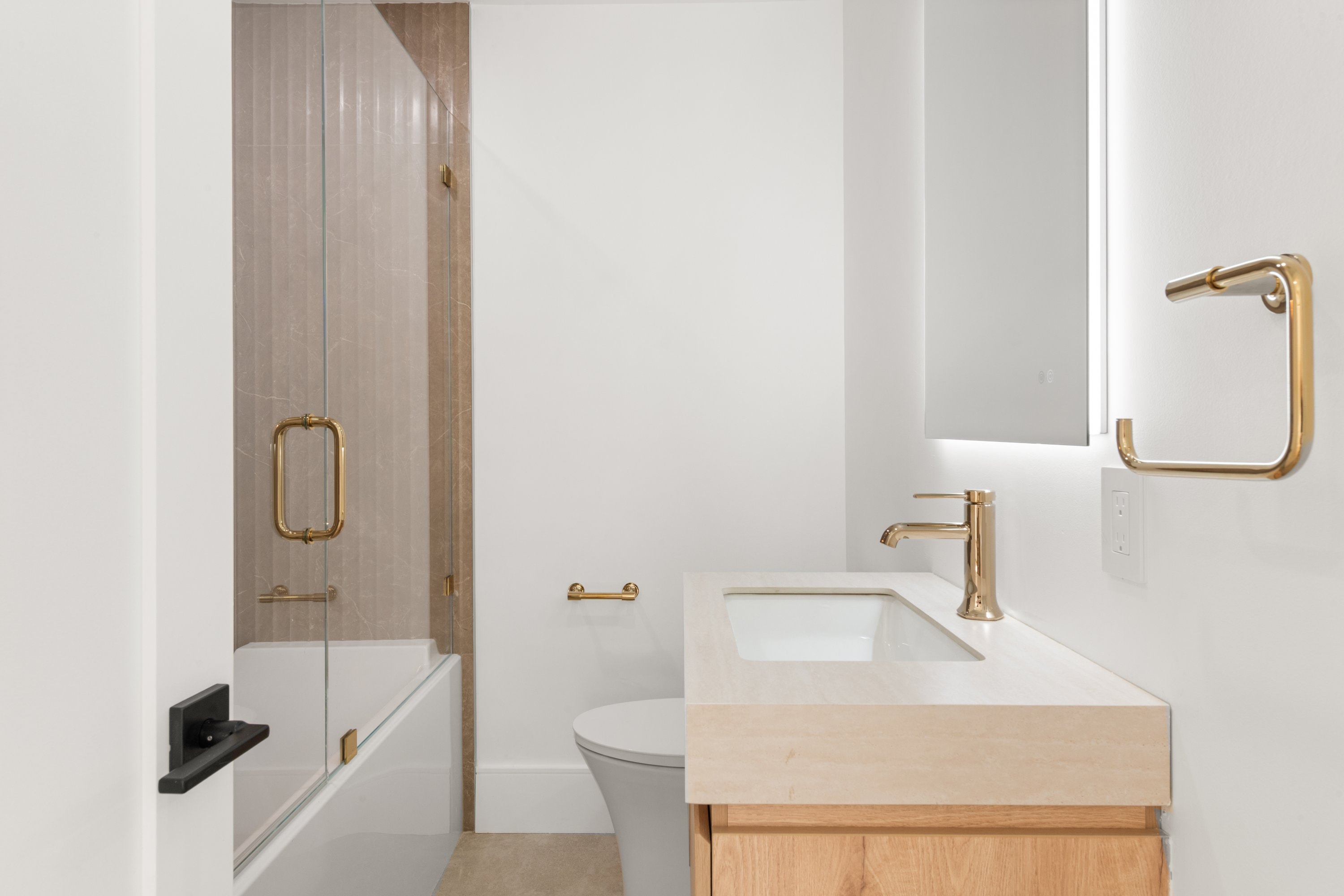 Ergon Builders custom bathroom with brass fixtures and marble, Fairfield County CT