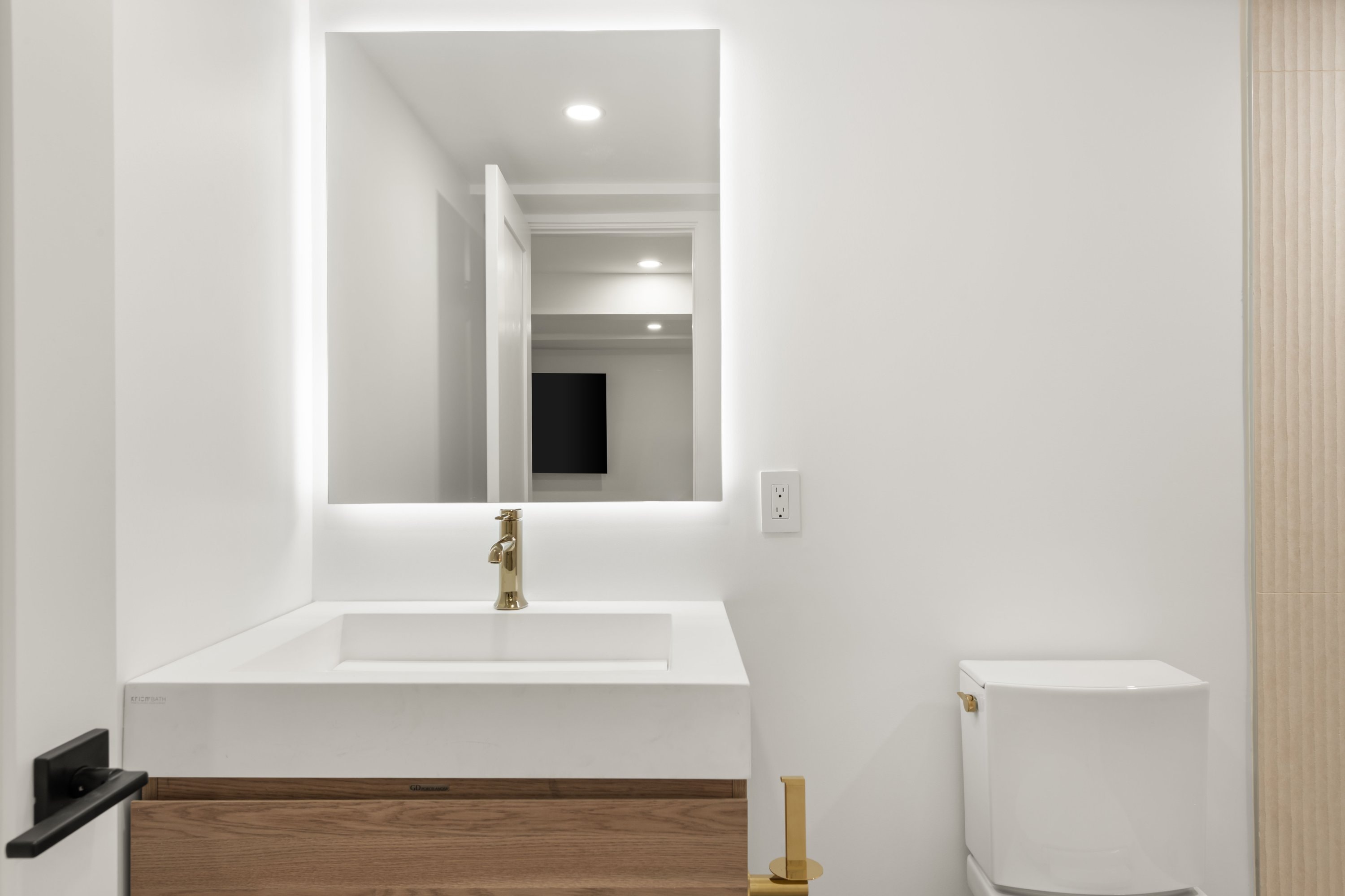 Ergon Builders modern bathroom with illuminated mirror, Fairfield County CT